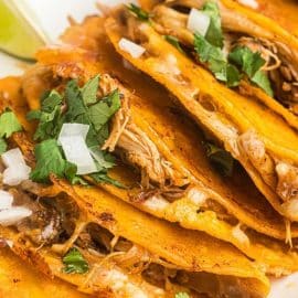 close up of birria tacos with toppings
