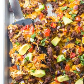 overhead shot of cauliflower nachos on a sheet pan