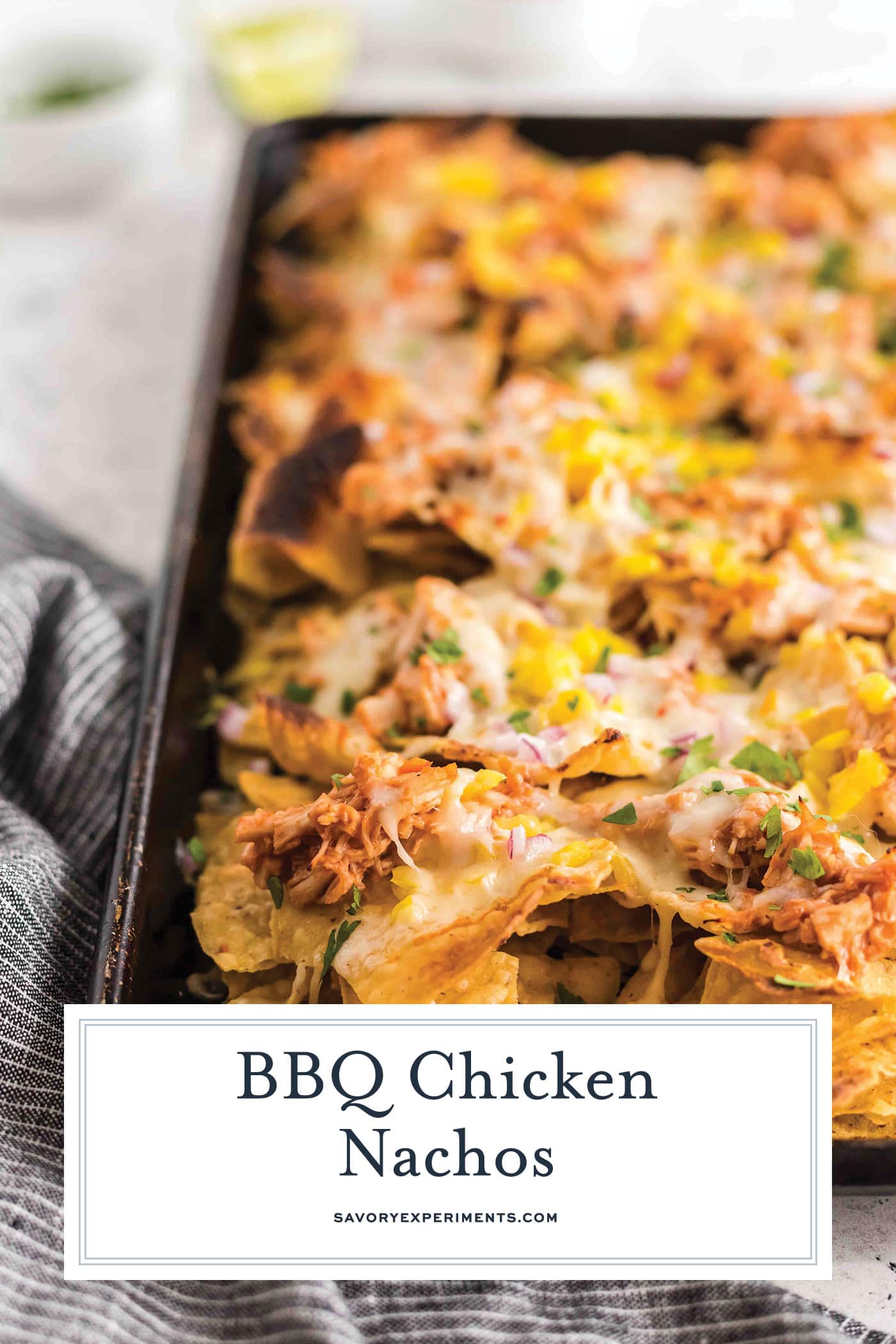 angled shot of bbq chicken nachos with text overlay for pinterest