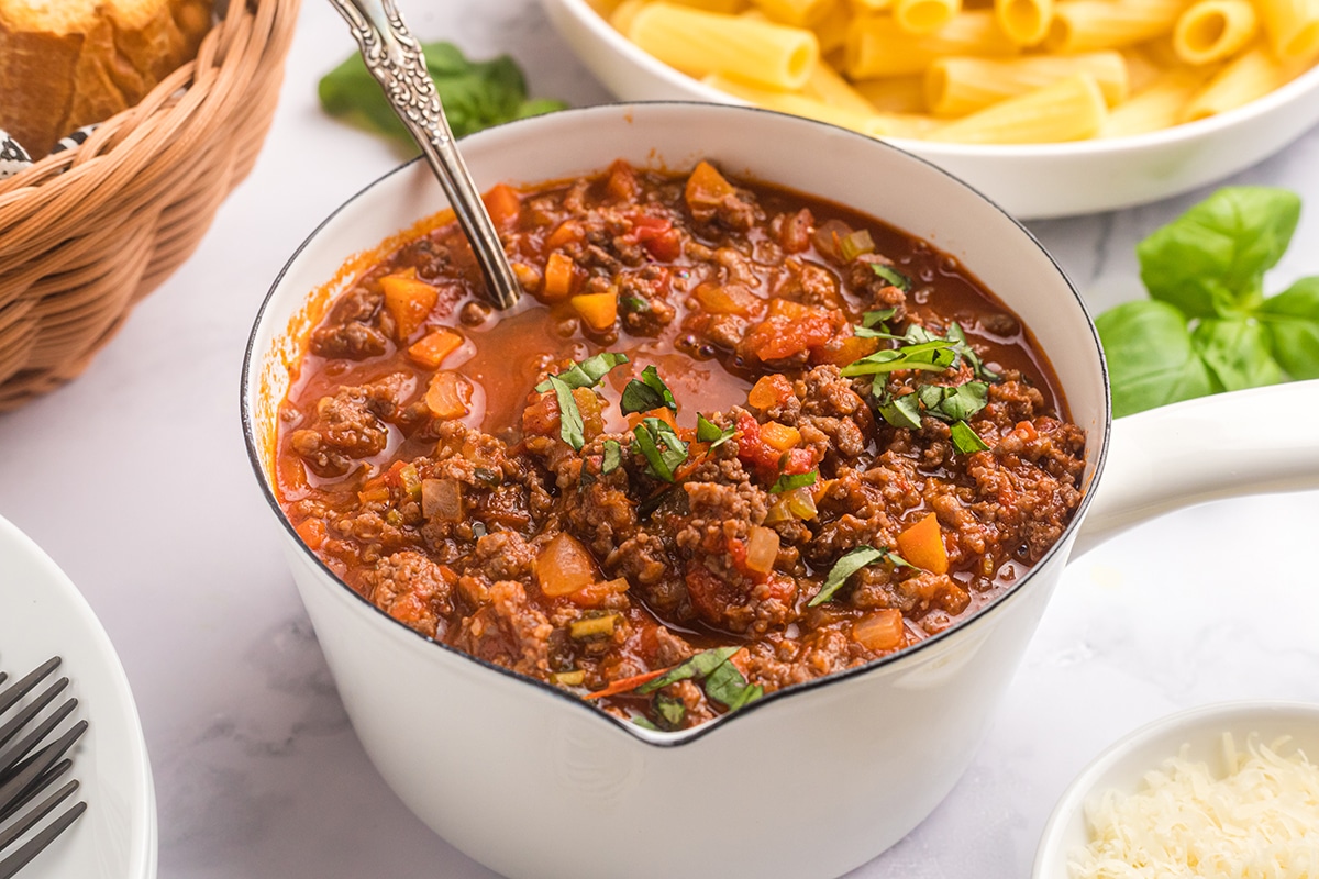 pot of bolognese sauce with spoon in it
