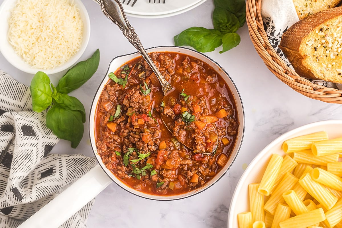 overhead shot of bowl of bolognese with spoon