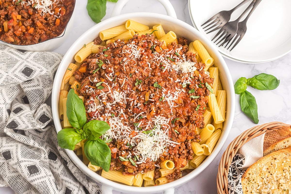 bowl of pasta topped with bolognese sauce