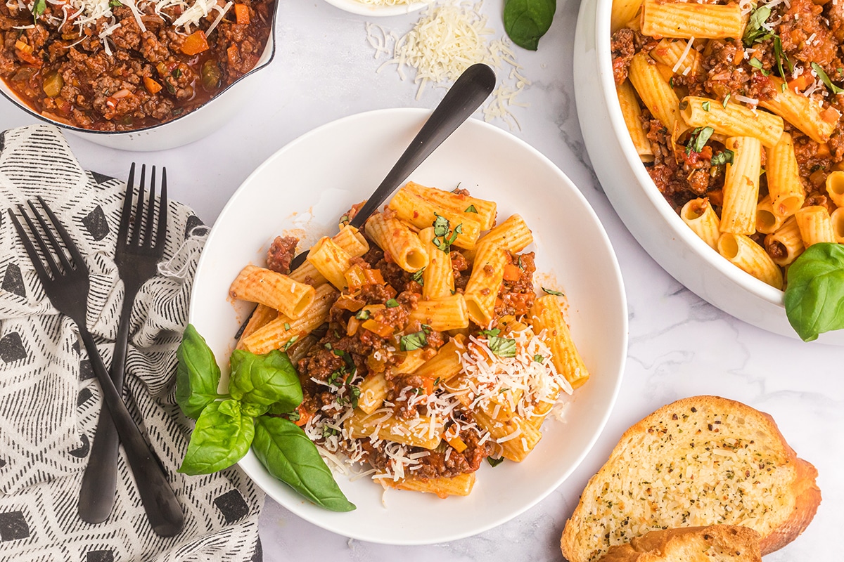 plate of pasta tossed in bolognese sauce