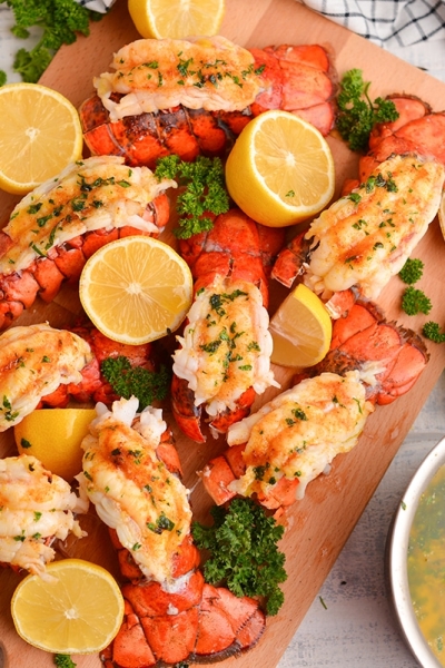 overhead board of lobster tails with fresh lemons and parsley