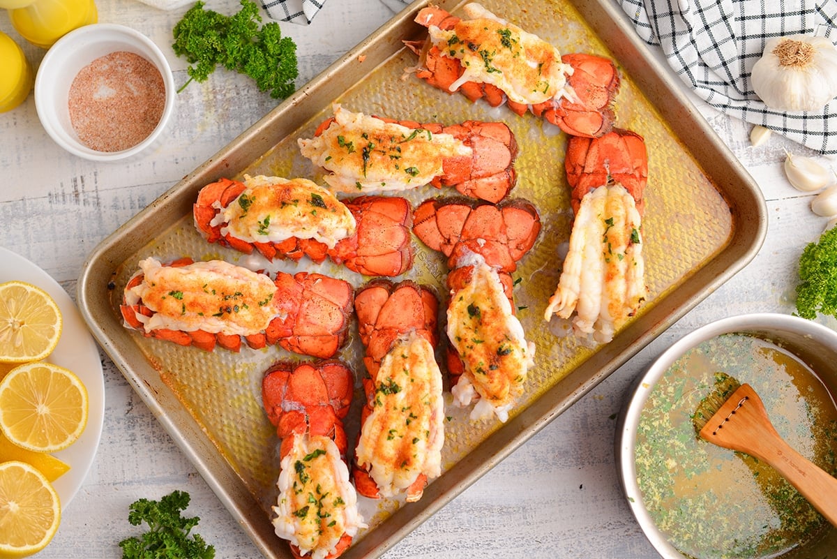 overhead of broiled lobster tails on a baking sheet