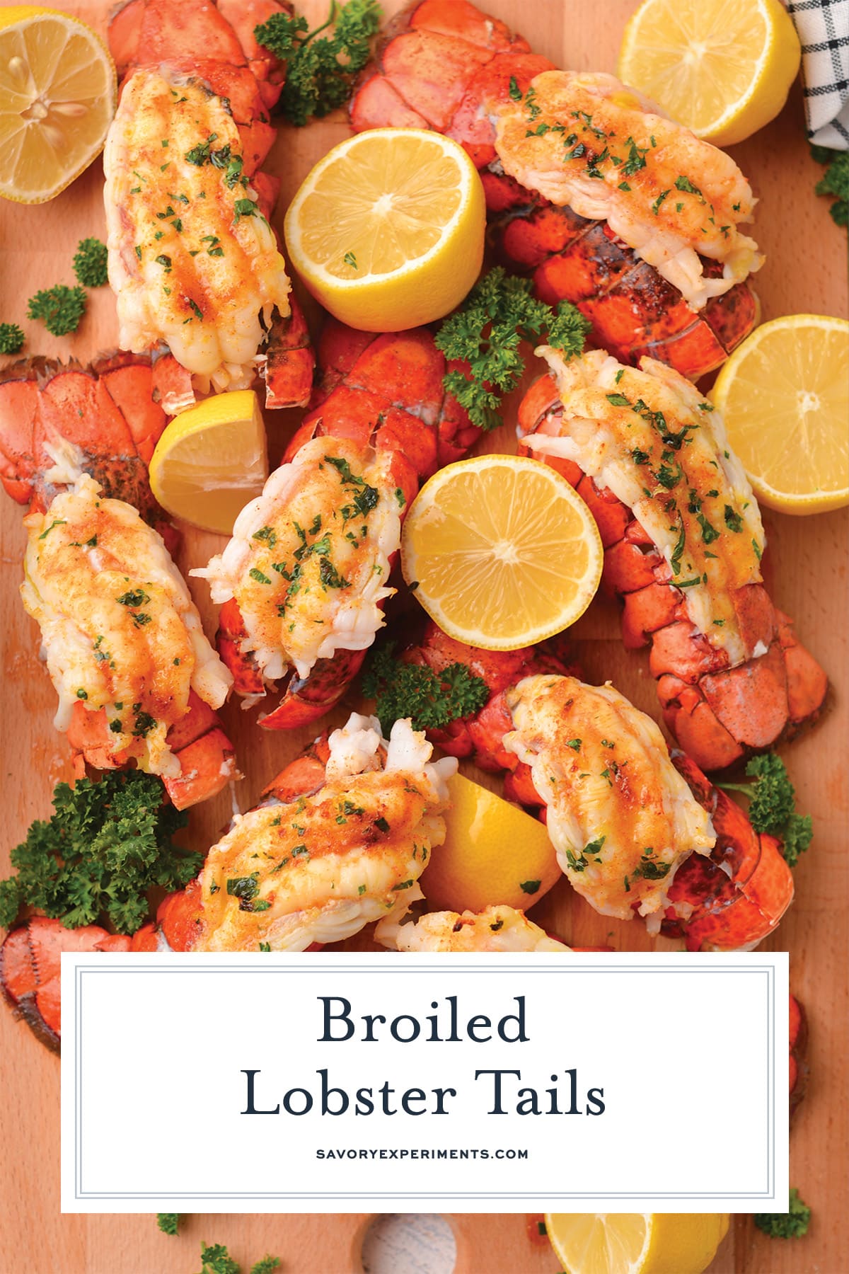 arranged board of lobster tails with lemons