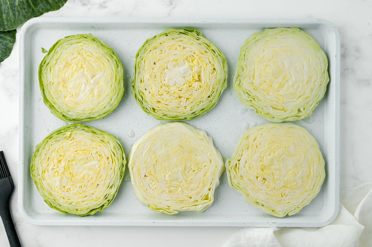 overhead shot of sliced cabbage on a sheet pan