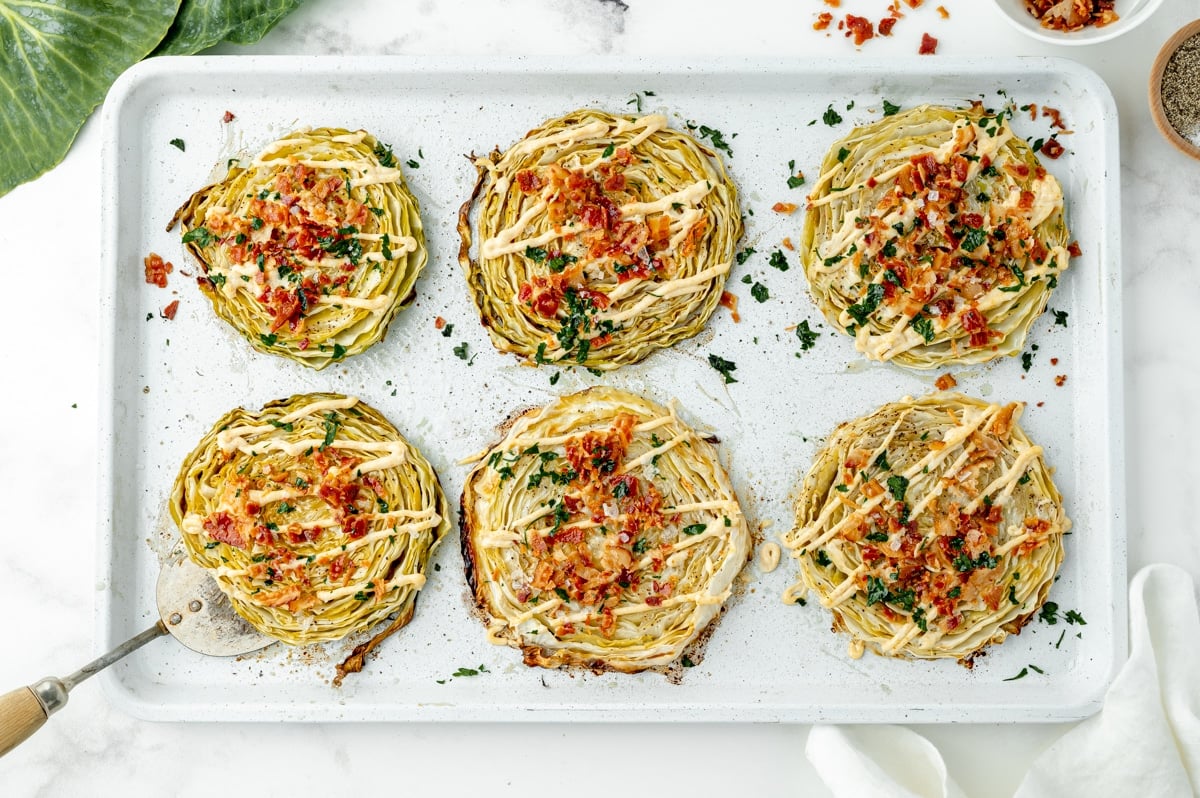 6 slices of baked cabbage on a sheet pan