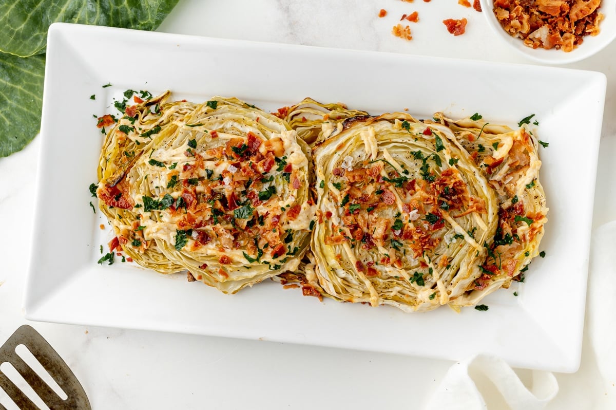 overhead shot of cabbage steaks on a serving tray