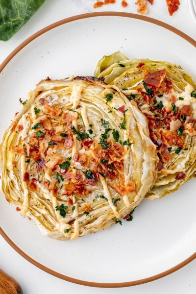 overhead shot of two cabbage steaks on plate