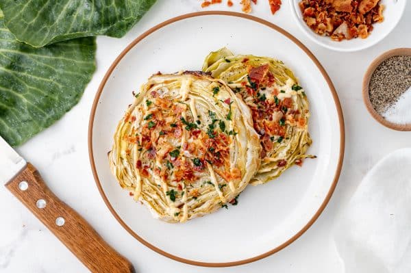 overhead shot of two cabbage steaks on plate