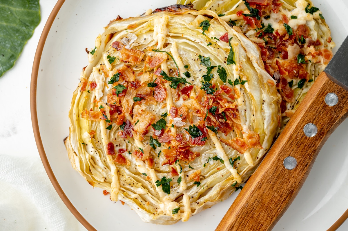 close up of two cabbage steaks on a plate