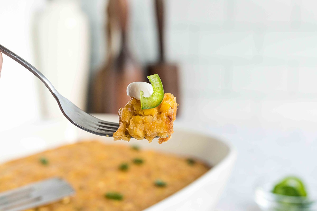 fork holding a bite of cornbread casserole