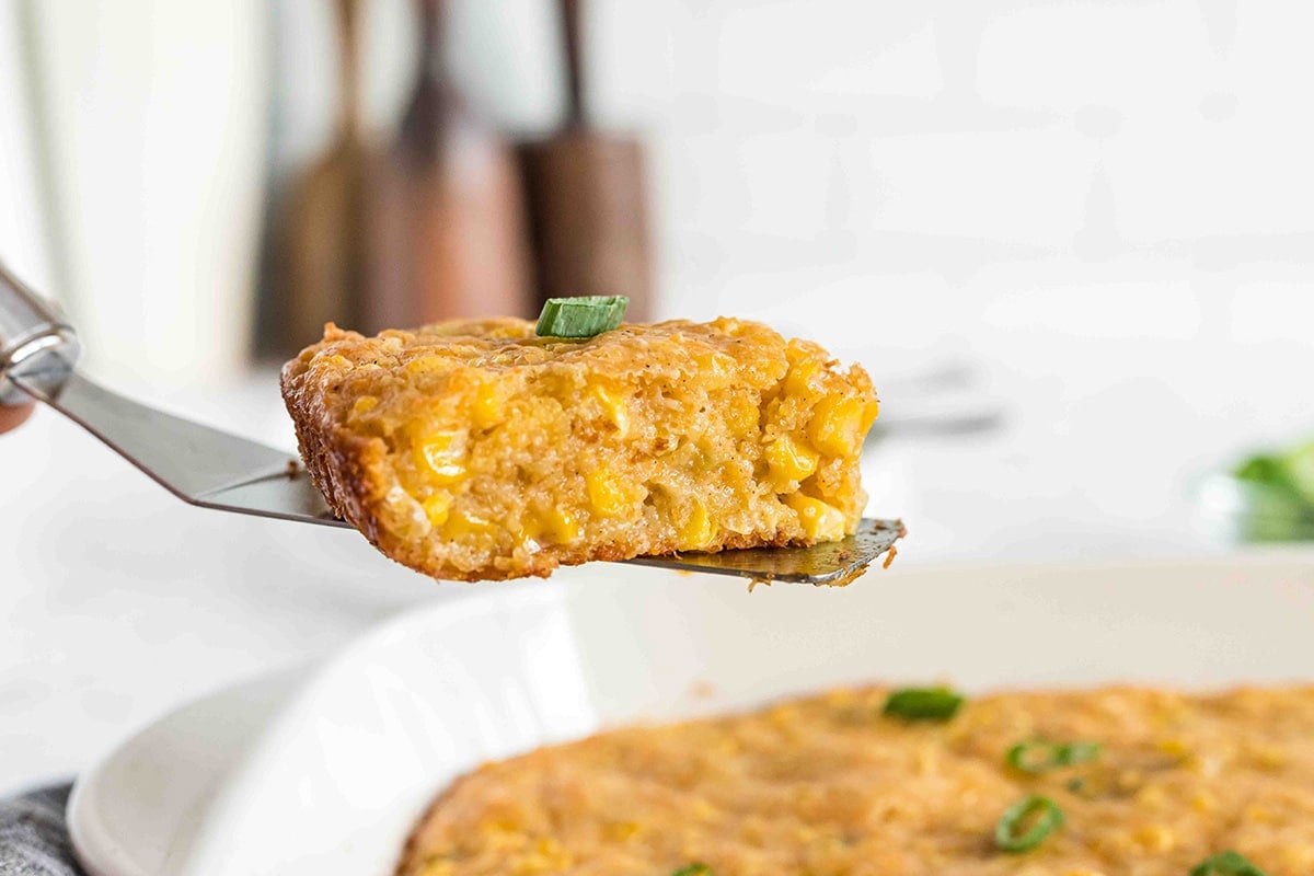 slice of cornbread casserole on a spatula