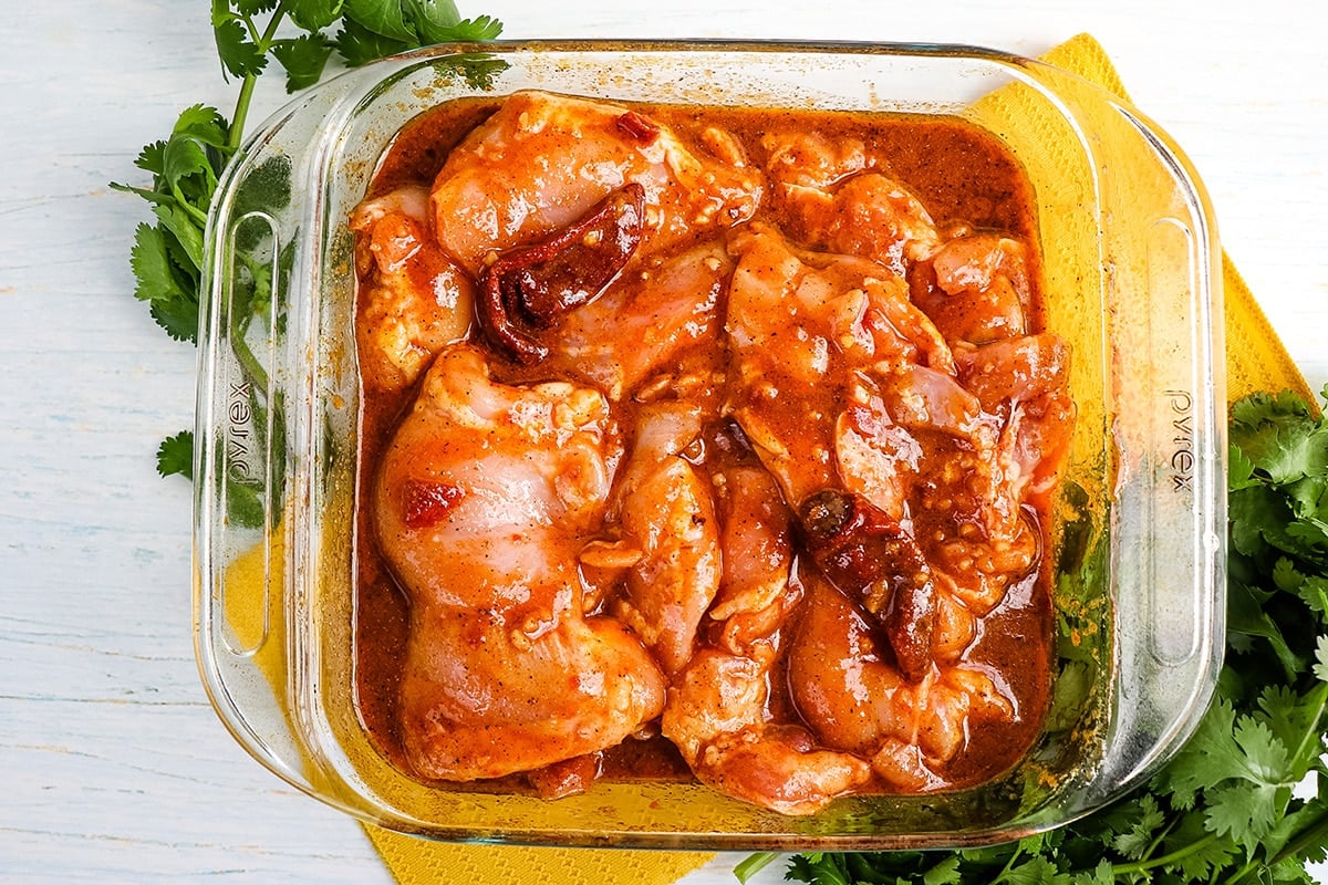 chicken marinating in a dish