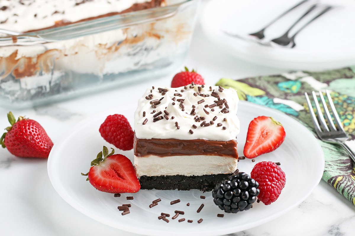 slice of chocolate lasagna on plate with fruit