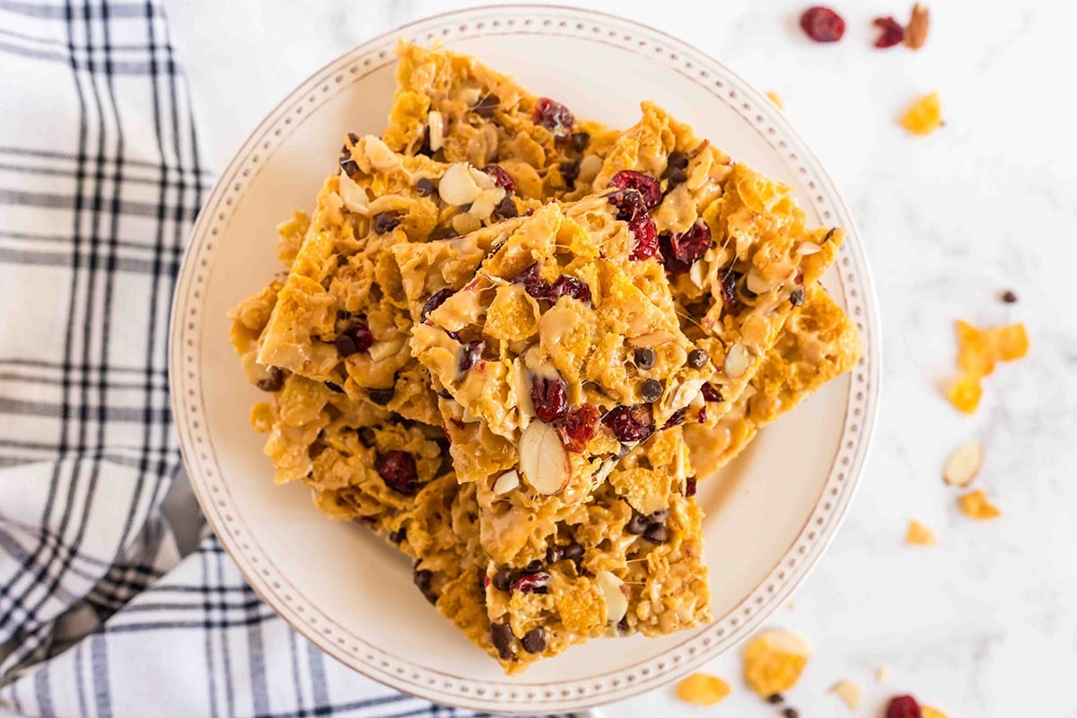 pile of peanut butter corn flake bars on a cream plate