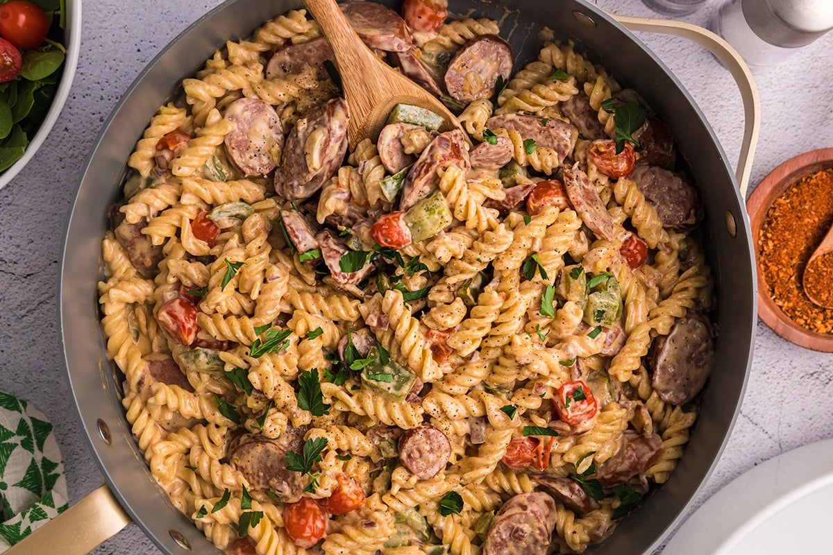 wooden spoon in pan of cajun pasta