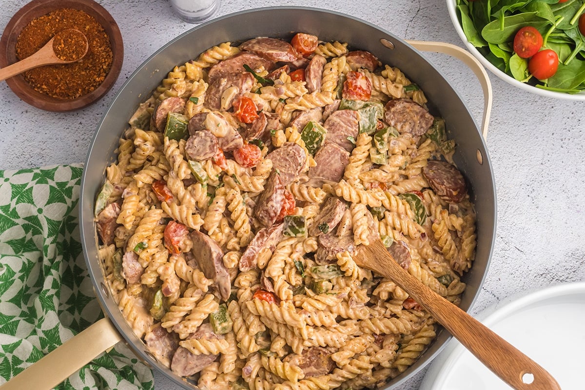 cajun pasta with wooden spoon in pan