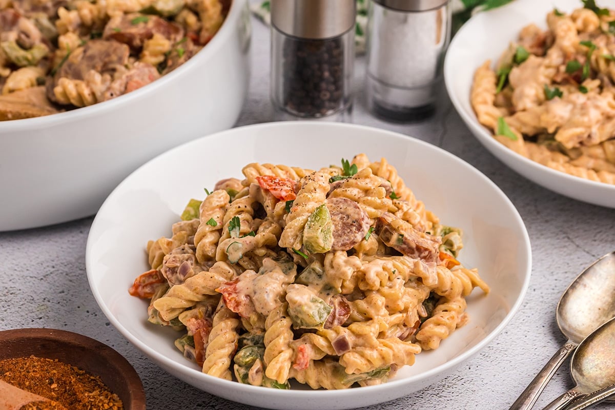 angled shot of creamy cajun pasta in a white bowl