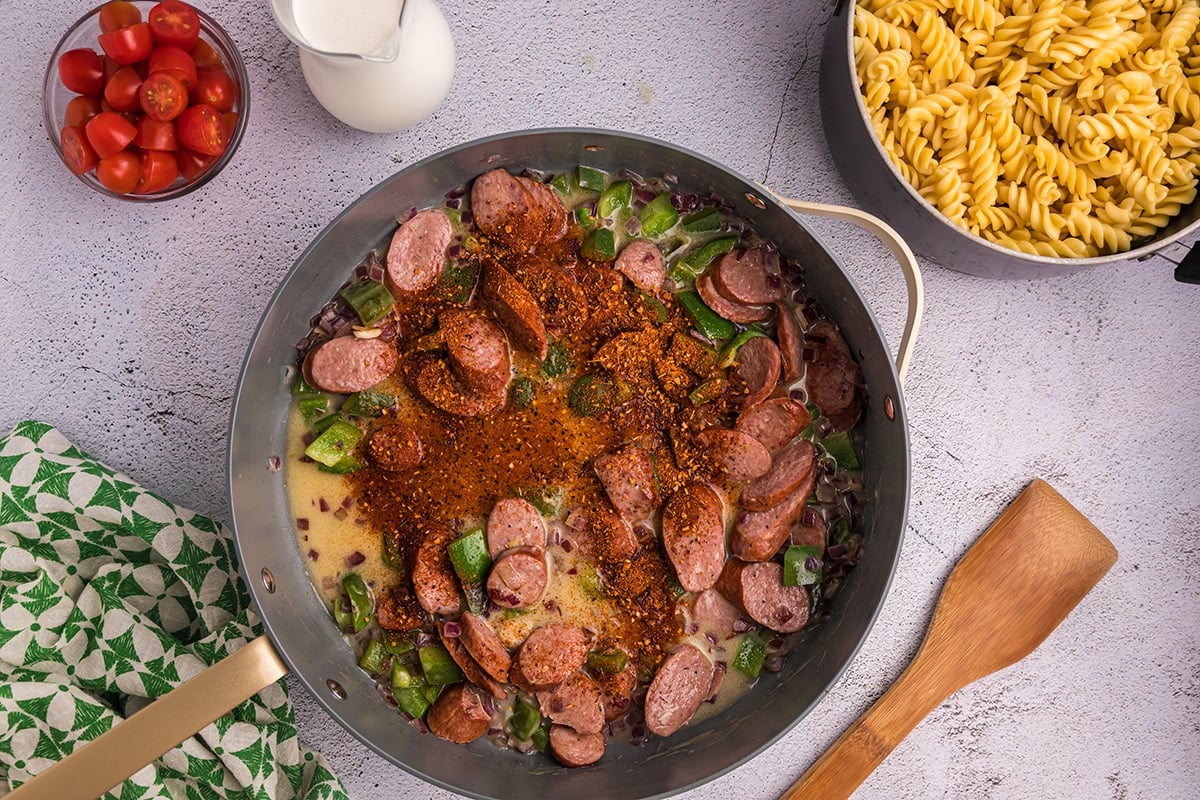 cajun seasoning added to sausage and veggies