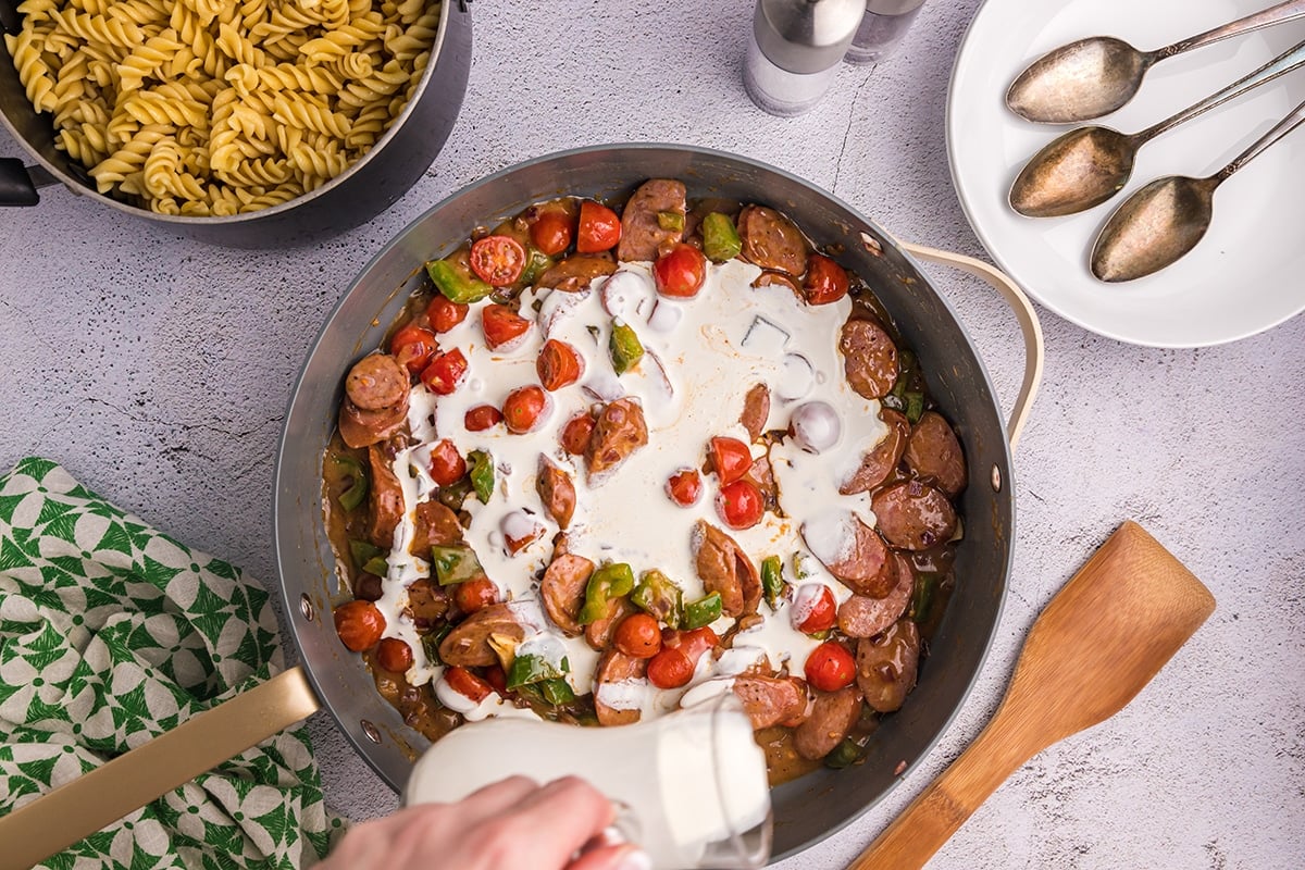 heavy cream poured into into sausage and veggies