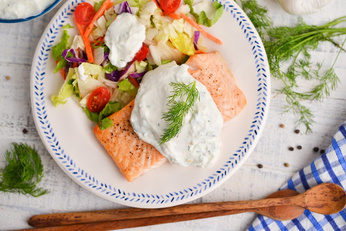 overhead shot of dill salmon on a plate with salad