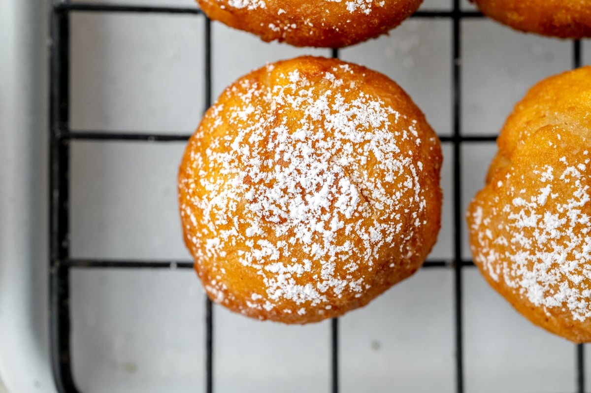 overhead shot of zeppole on cooling rack