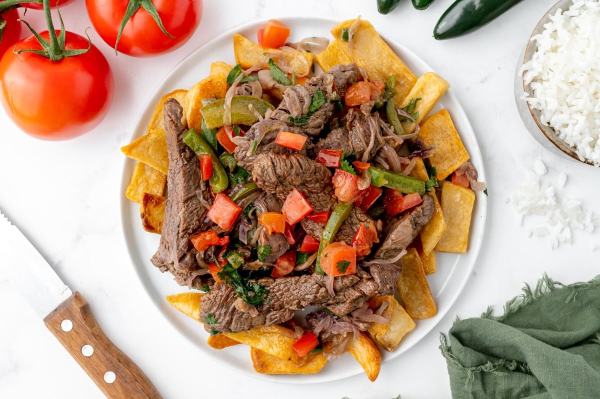 overhead shot of lomo saltado over fries