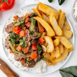 overhead plate of lomo saltado with rice and fries