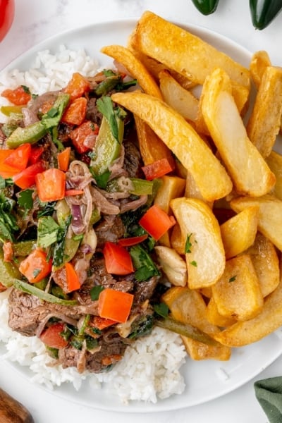 overhead plate of lomo saltado with rice and fries