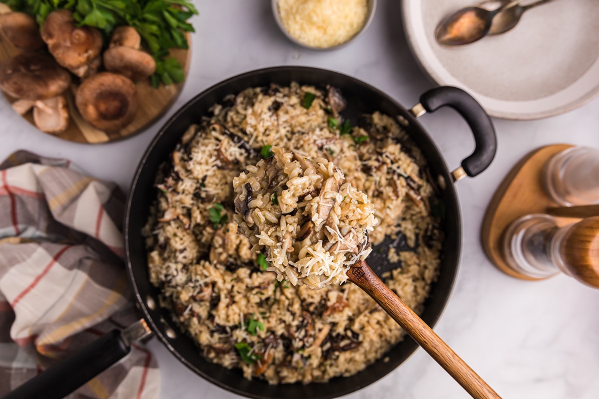 wooden spoon full of mushroom risotto