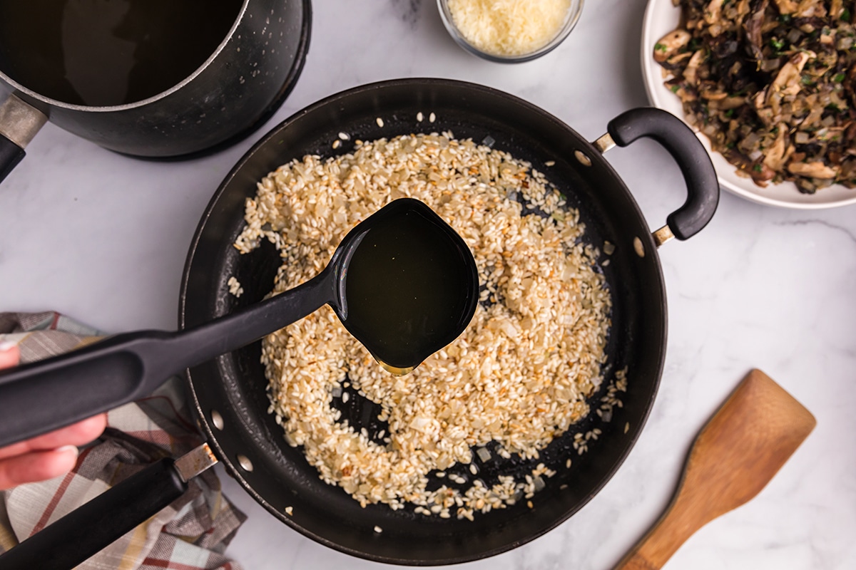 broth poured into rice in skillet