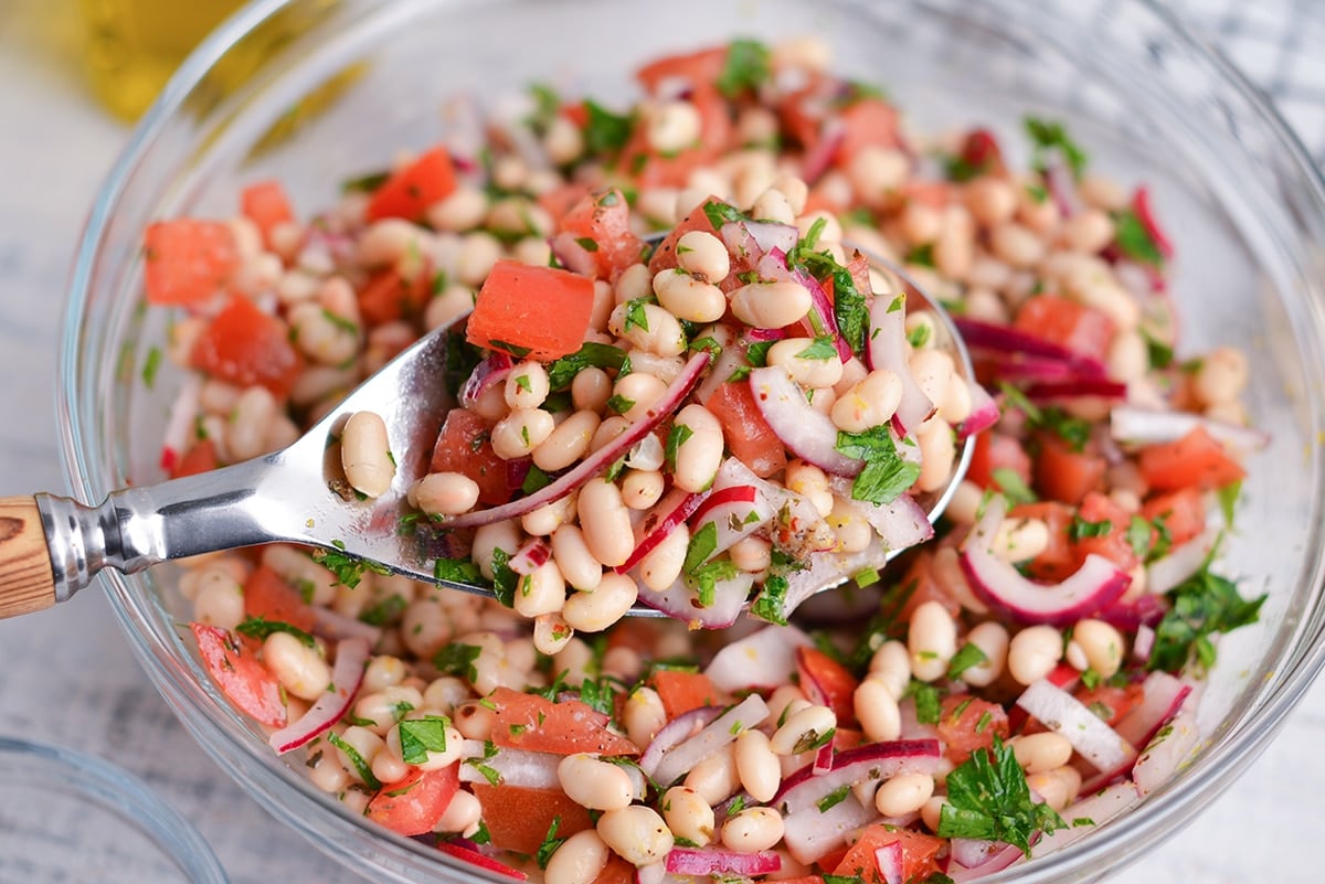 close up of a spoonful of navy bean salad