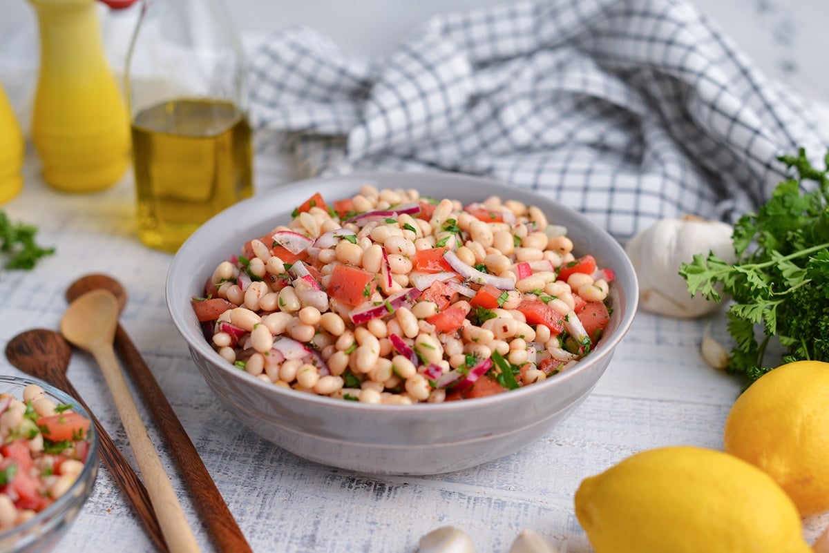 head on view of navy bean salad with tasting spoons