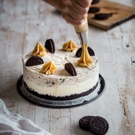 icing piped onto oreo ice cream cake