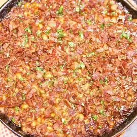 overhead shot of skillet of peach bbq baked beans