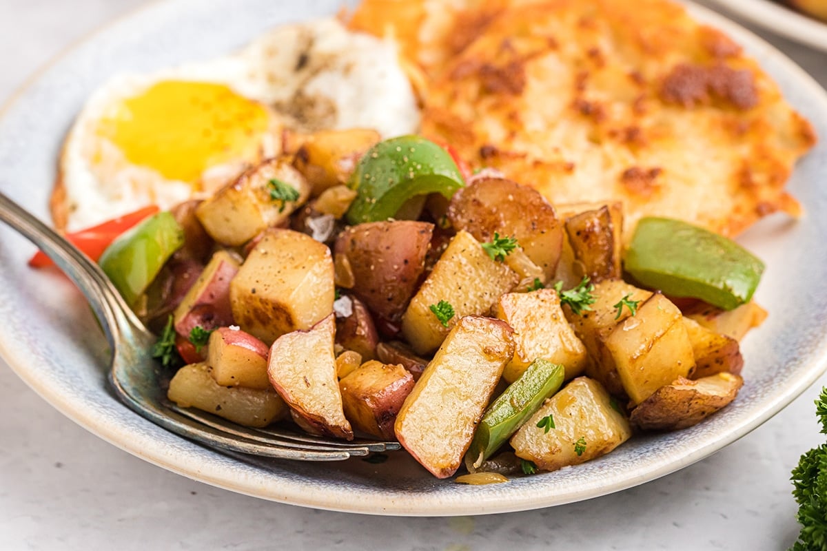 angled shot of plate of potatoes o'brien