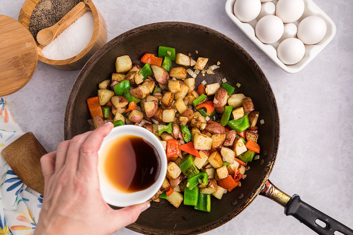 sauce added to pan of potatoes and peppers