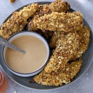 plate of pretzel crusted chicken tenders with sauce