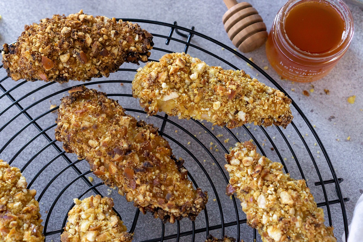 chicken tenders on a cooling rack with honey