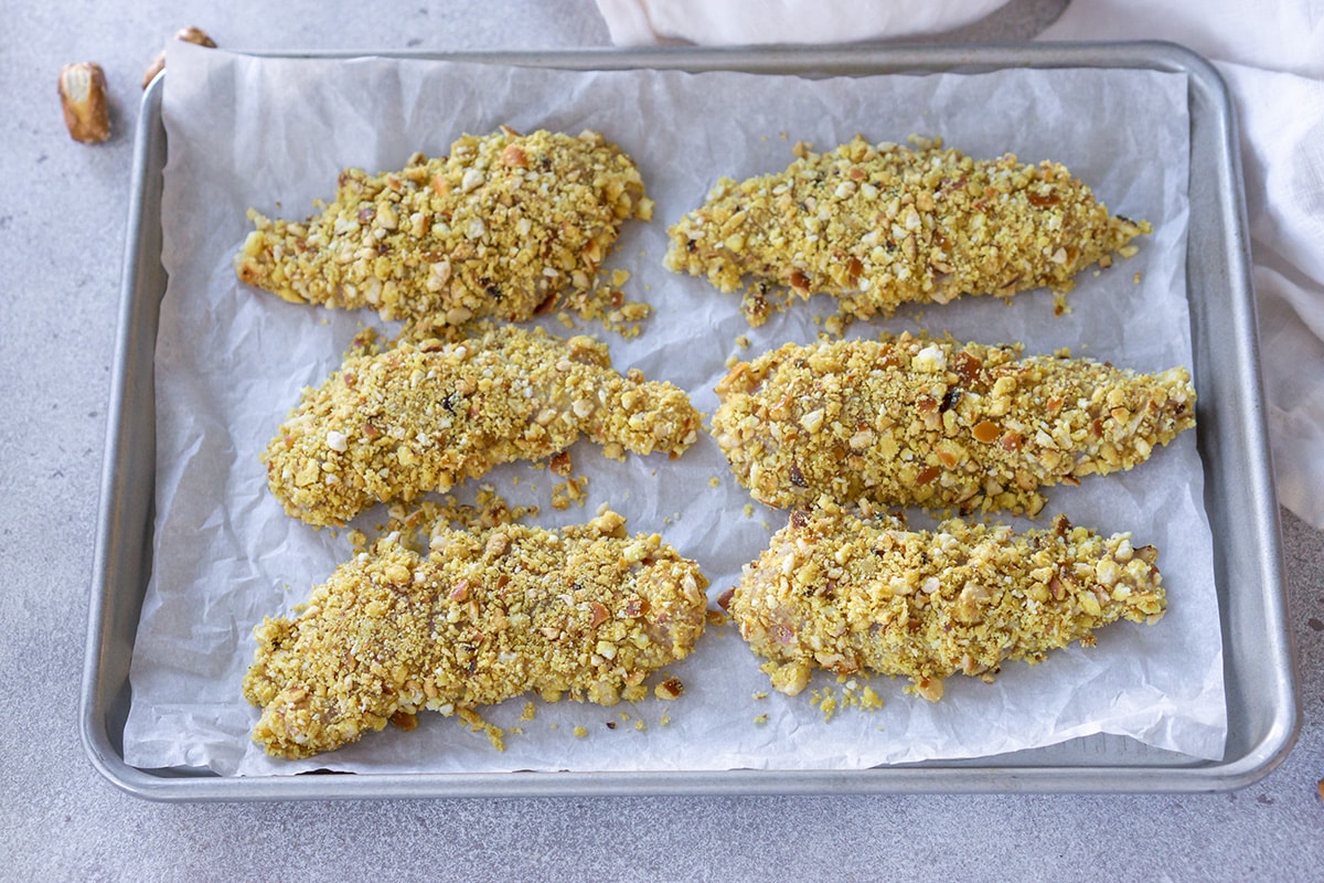 pretzel crusted chicken tenders on a tray