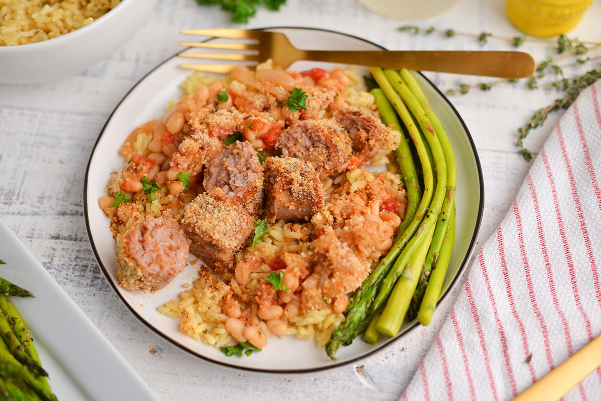 sliced sausage with rice on a dinner plate