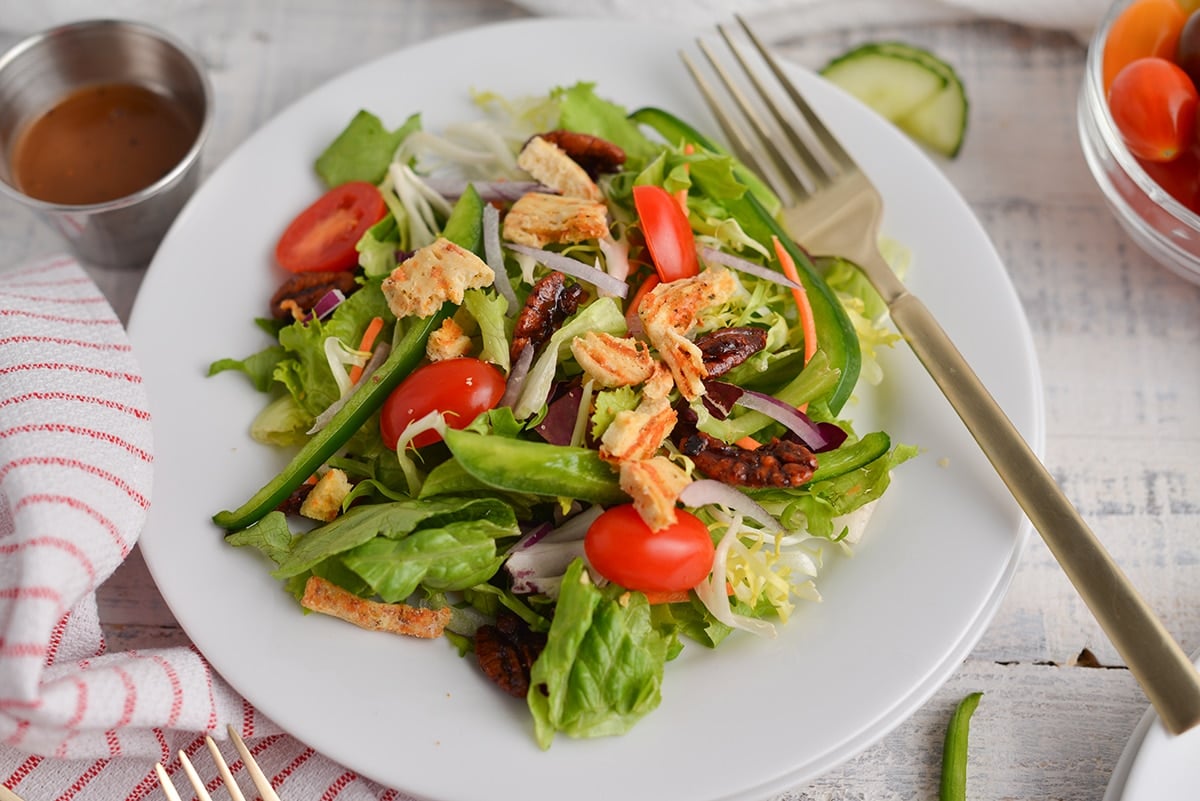 angle of side salad with a gold fork