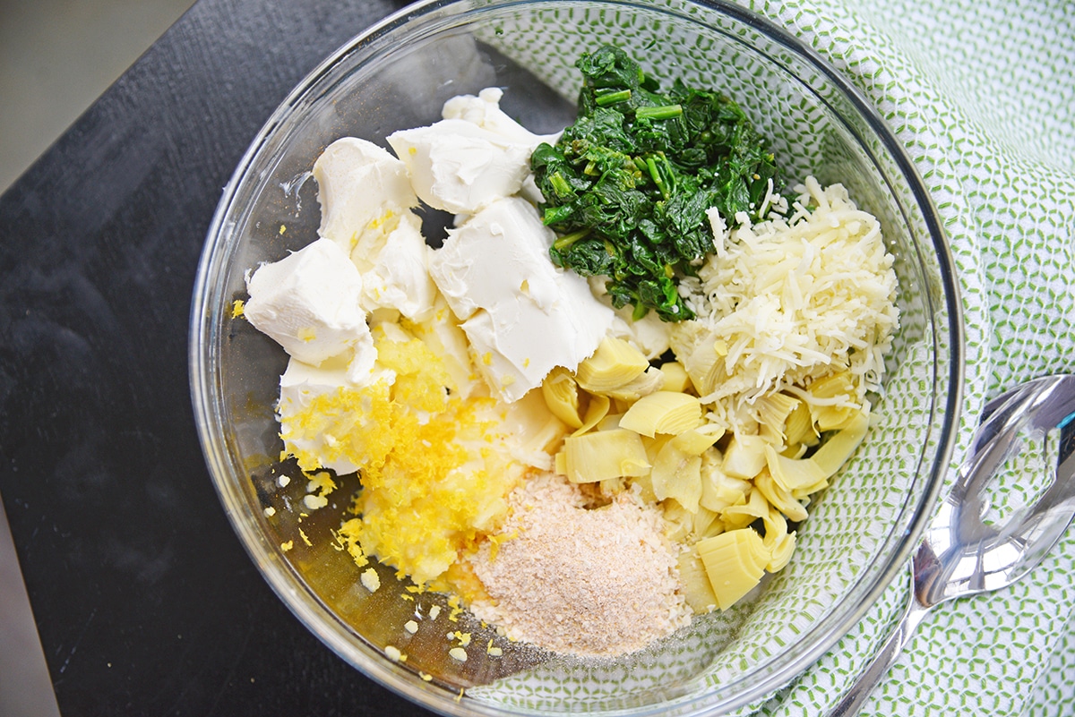 overhead mixing bowl with ingredients for spinach and artichoke dip