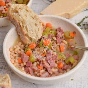 crusty bread in a bowl of ham soup