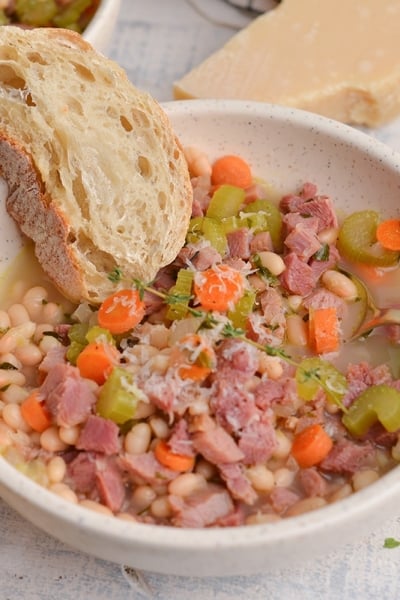 crusty bread in a bowl of ham soup