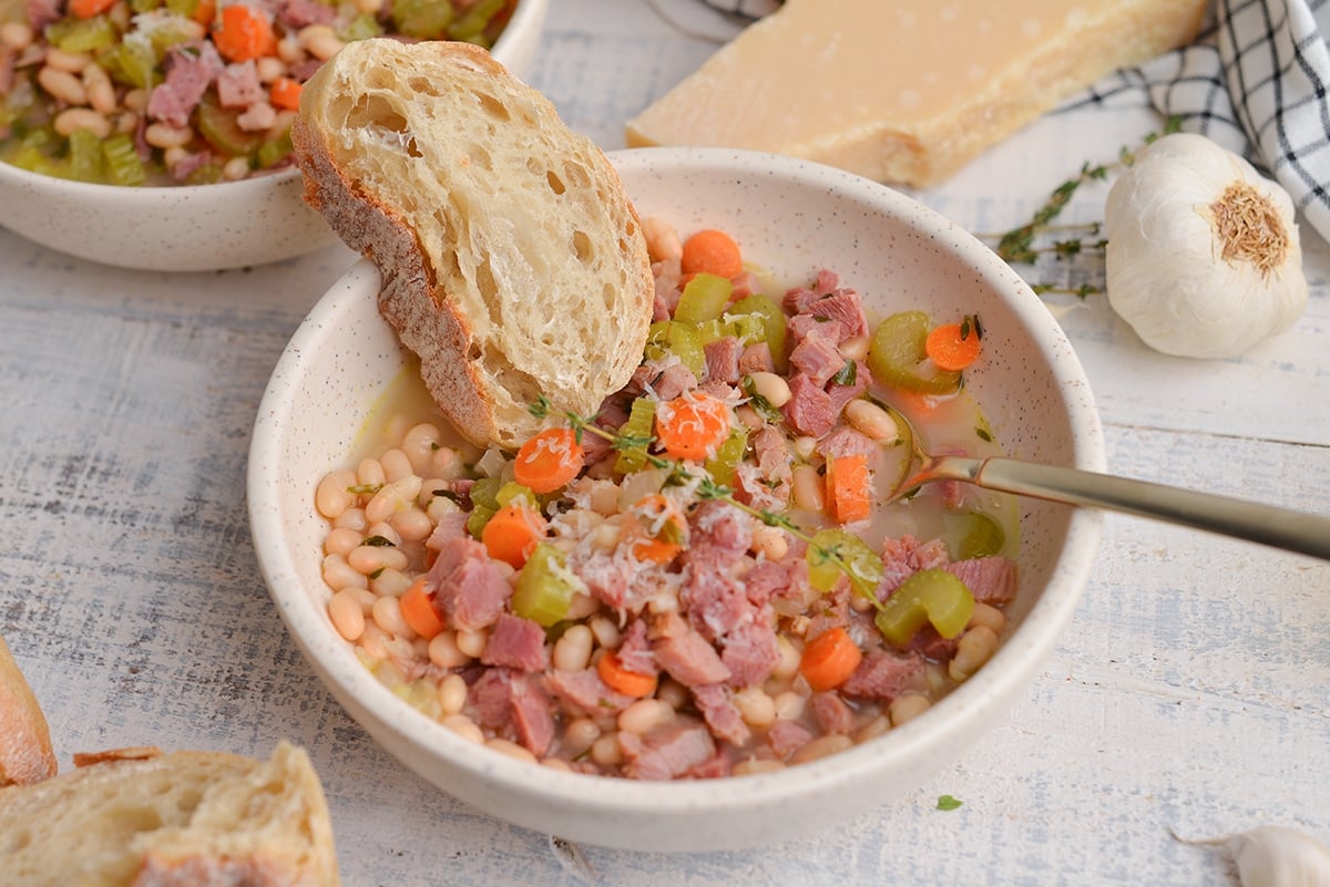 crusty bread in a bowl of ham soup