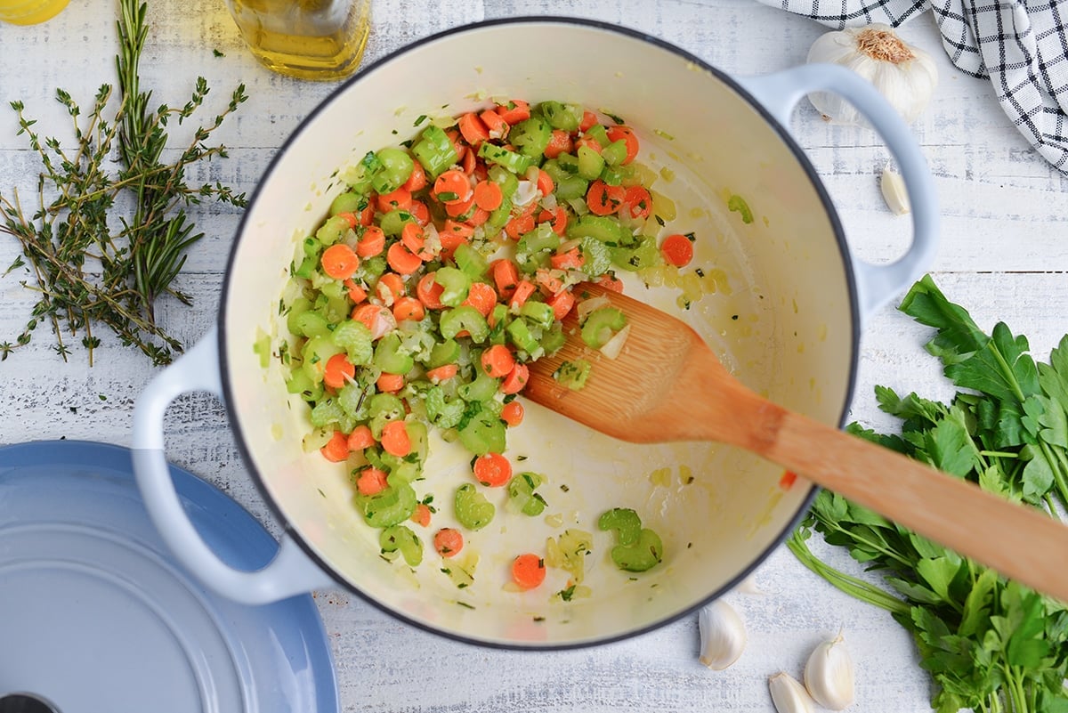 sauteing veggies with fresh herbs in a Dutch oven