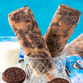 two oreo popsicles in a glass